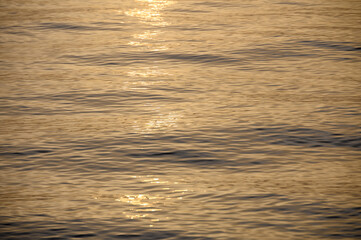 sun sets on a dramatic cloudy sky over the Mediterranean Sea horizon with a warm, golden glow.2