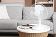 © Pixel-Shot - Modern electric fan on coffee table in living room