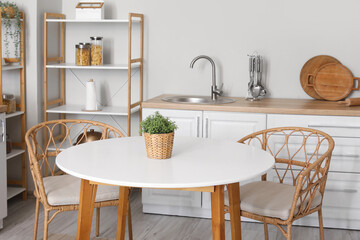 Sticker - Interior of modern stylish kitchen with wicker chairs and table