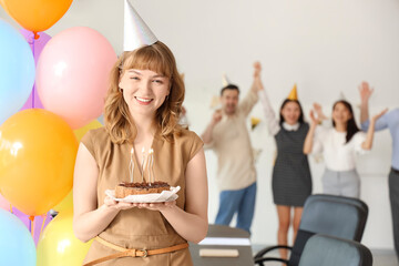 Canvas Print - Young businesswoman with cake at birthday party in office