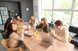 © Pixel-Shot - Business colleagues having lunch at table in office kitchen