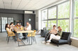 © Pixel-Shot - Business colleagues having lunch in office kitchen