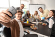 © Pixel-Shot - Group of business people taking selfie during lunch in office