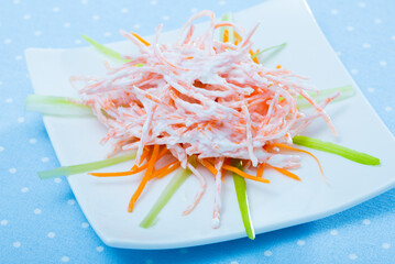 Wall Mural - Healthy fresh carrot salad with sour cream and garlic served on white plate..