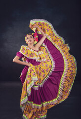 Wall Mural - A woman in a colorful dress is dancing