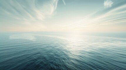 Wall Mural - The sea stretching into the distance under a pale morning sky, where wispy clouds float above faintly glistening waters.