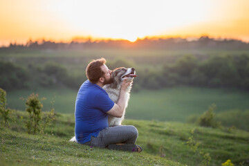 Happy dog and man playing outdoor