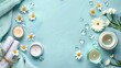 © LukaszDesign - Spa products candle and flowers arranged neatly on light blue surface Text space available