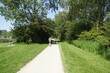 © Thijs de Graaf - Path along the lake from the Dutch Geestmerambacht recreation area near Alkmaar. Hikers, jogger, trees, grass. Spring. May, Netherlands
