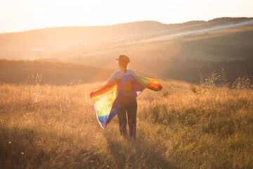 Wall Mural - Young woman with LGBT flag.