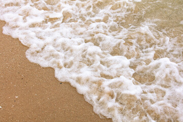 Sticker - Yellow sand on the seashore as an abstract background. Texture