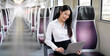 © NAMPIX - Young woman working on laptop in the train,