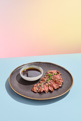 Sticker - Succulent beef alternative steak presented with a rich dipping sauce, styled for a modern culinary experience