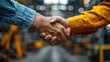 © Claudine - two co workers shaking hands as they visiting a building site with stock image