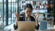 © Irina Ukrainets - Woman frustrated with work on laptop in modern office. Office stress. Conceptual image showing frustration and stress at work. AI