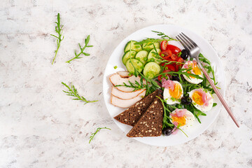 Wall Mural - Healthy breakfast. Boiled egg, chicken ham, bread and fresh salad. Keto breakfast. Top view, overhead