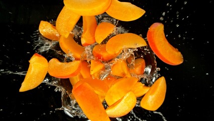 Poster - Freeze Motion of Flying Apricots into Water, Black Background.
