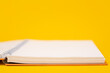 © FOTO SALE - Orange book on yellow educational background White paper for studying and taking notes.