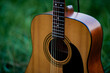 © FOTO SALE - Acoustic guitar, orange string musical instrument placed in the area of trees and grass, playing music in the forest and relaxing.