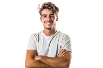 Young Man in Casual Attire Standing Joyfully with Crossed Arms