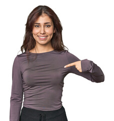 Wall Mural - Middle Eastern woman in studio person pointing by hand to a shirt copy space, proud and confident