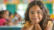 © mattegg - Happy Hispanic girl learning during class at elementary school and looking at camera
