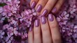 © Marry - A beautiful woman's hands adorned with a purple fashionable spring nail design are elegantly showcased.
