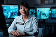 © pressmaster - Happy young Hispanic woman in uniform looking at camera with smile while sitting by workplace with computer monitor