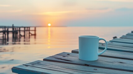 Wall Mural - A blank gourmet coffee mug positioned on an old wooden pier at dawn, the calm sea and rising sun creating a tranquil morning coffee setting.
