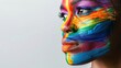 © vlabcolor - Portrait of non-binary person with rainbow face paint, confident expression, close-up, isolated white background, artistic and bold, vibrant colors, copy space.