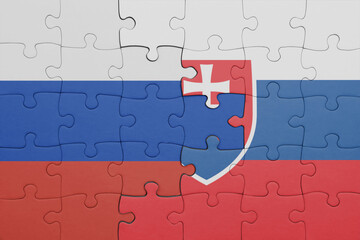 puzzle with the colourful national flag of slovakia and flag of russia.
