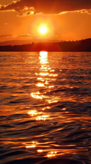 Wall Mural - The sun is setting over the water, creating a beautiful and serene atmosphere
