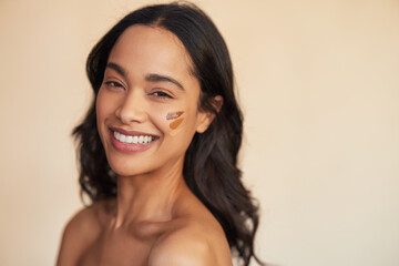 Canvas Print - Multiethnic woman trying different tones of liquid foundation on face