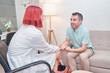 © Oscar - therapist holds her patient's hand in a mental health session.