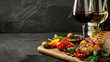 © Curva Design - two glasses of wine with Charcuterie board on dark black background with copy space.