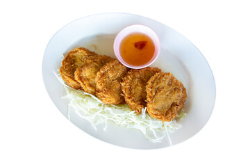 Wall Mural - Top view of Crispy Thai Prawn Cake on white oval plate, focus selective