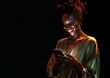© LU - A young woman smiles as she looks at her cell phone, which has a black background, Happy woman using cell phone