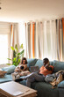 © Camelia Elisabeta Utalea/Stocksy - A FAMILY IN THE LIVING ROOM OF THEIR HOUSE