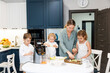 © Nata Segueza/Stocksy - Family Cooking Together in a Modern Kitchen During Daytime