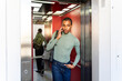 © Alba Vitta/Stocksy - Man use phone elevator
