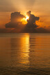 © Tim Booth/Stocksy - Sunset through clouds