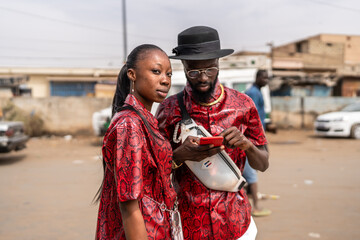 Couple with mobile phone outdoors.