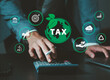 © MrPanya - Environmental tax breaks concept. Businessman touching green taxes icons.Using environmental taxes, carbon tax, environmentally beneficial tax incentives in order to achieve environmental targets.