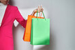 © Marc Tran/Stocksy - A woman in a trendy outfit holding shopping bags