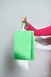 © Marc Tran/Stocksy - cropped view of woman with shopping bags