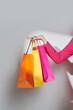© Marc Tran/Stocksy - Cropped image of a woman holding shopping bags