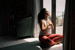 © Nicola Suttle/Stocksy - Peaceful woman meditating in lotus pose