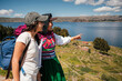 © Luis Herrera/Stocksy - indigenous woman walking with tourist. local tourism