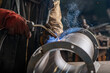 © Olena Smyrnova/Stocksy - Male welder wearing a protective mask is welding stainless pipe
