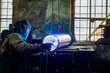 © Olena Smyrnova/Stocksy - Male welder is welding stainless pipe in industrial workshop